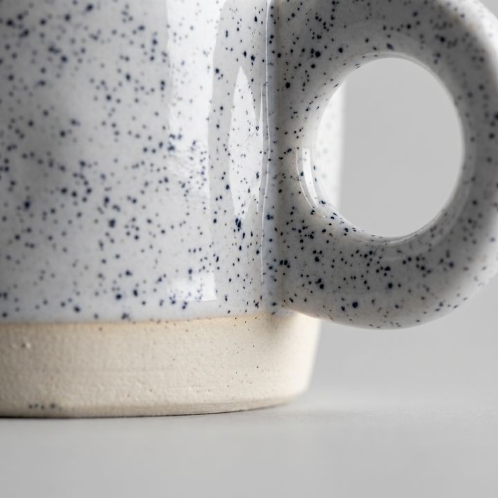 Macro close-up of the mug's ring handle and glaze texture